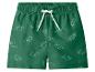 Short de bain vert avec imprimé dinosaures et cordon blanc.