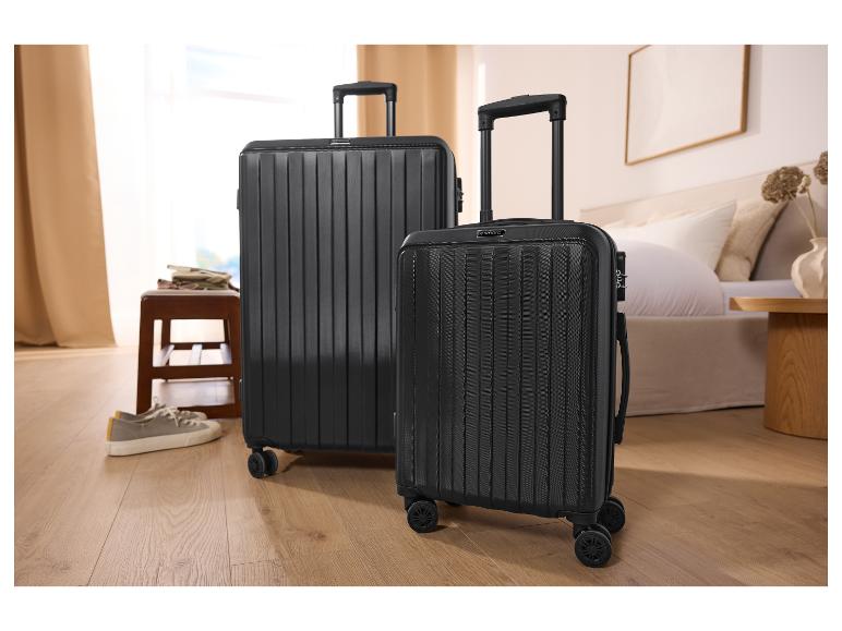 Deux valises noires ESMARA® de tailles différentes dans une chambre.