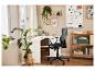 Bureau d'angle blanc avec chaise de bureau noire, étagère en bois et tableau blanc.