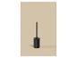 Brosse de toilette noire avec support sur fond beige.