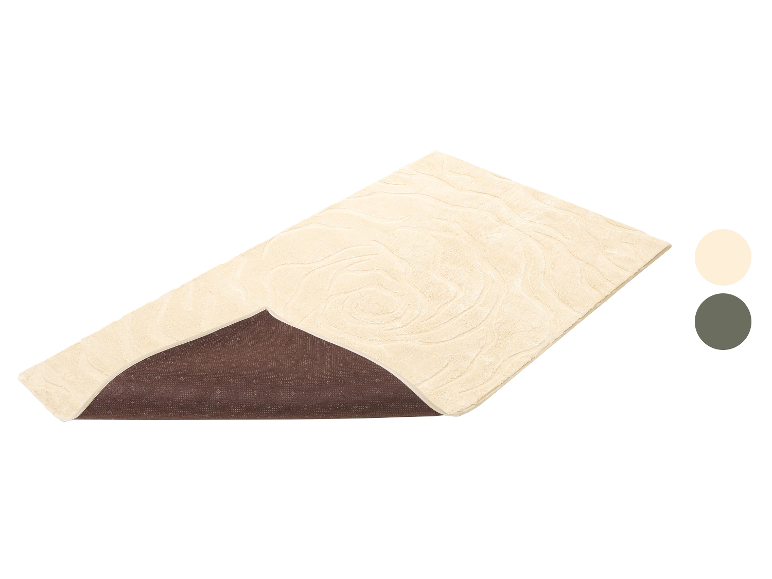 Tapis de bain beige avec motif ondulé et base antidérapante.