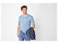 Homme en t-shirt rayé bleu et jean, tenant une veste bleue.