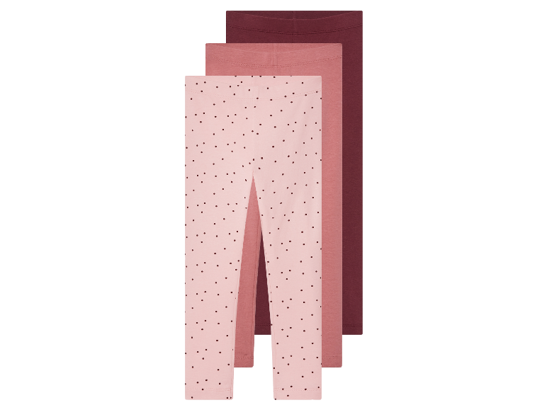Trois leggings pour filles dans des tons rose et bordeaux.