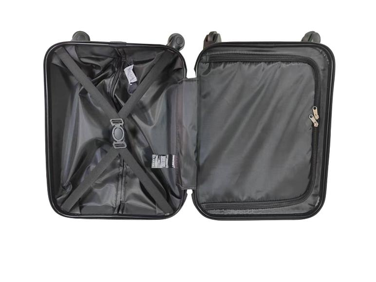 Valise de voyage ouverte avec doublure noire, sangles de maintien et compartiment zippé.