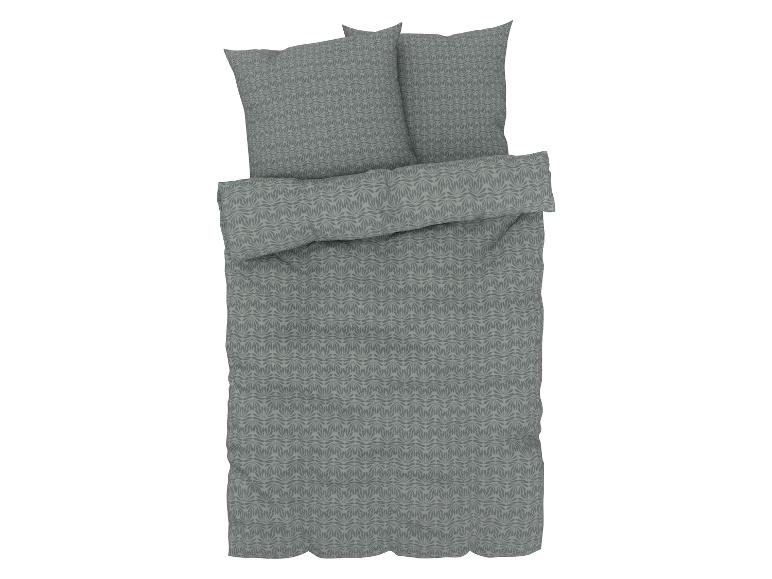 Une housse de couette avec deux taies d'oreiller en vert avec un motif floral.