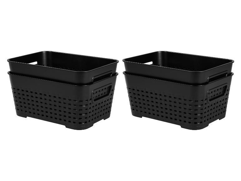 Deux ensembles de paniers noirs en plastique tressé pour le rangement.