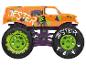 Un monster truck orange avec de grandes roues et l'inscription 'Jester' sur le côté.