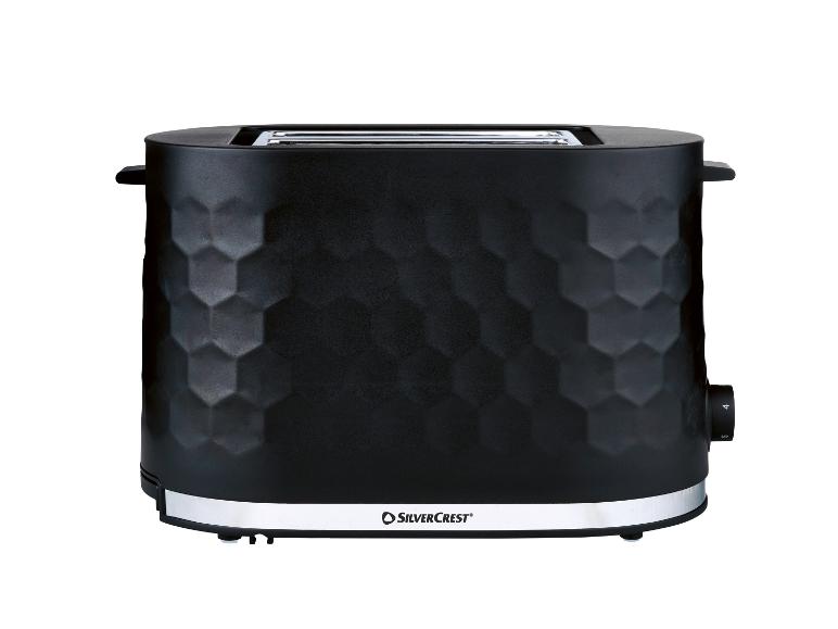 Grille-pain noir avec motif hexagonal et base argentée.