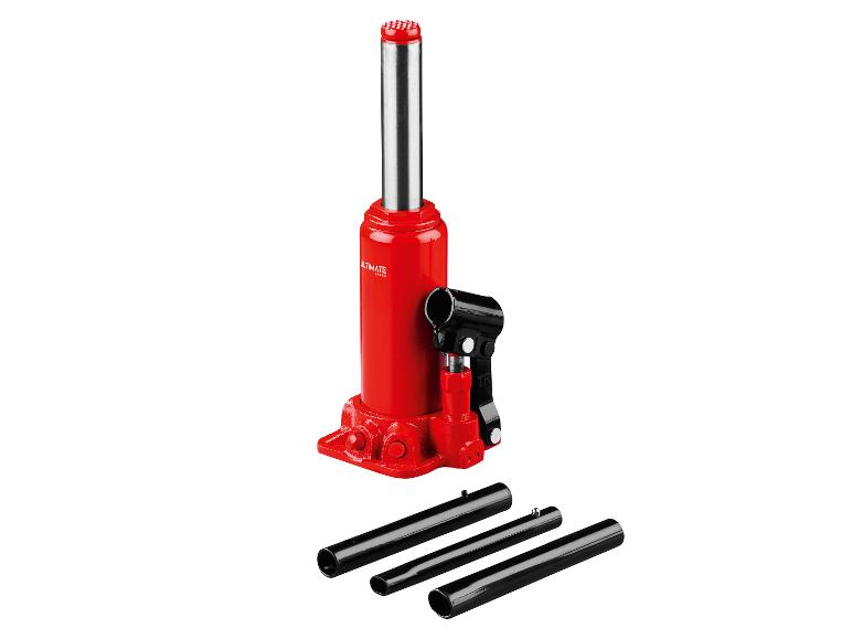 Cric hydraulique rouge avec accessoires noirs sur fond blanc.
