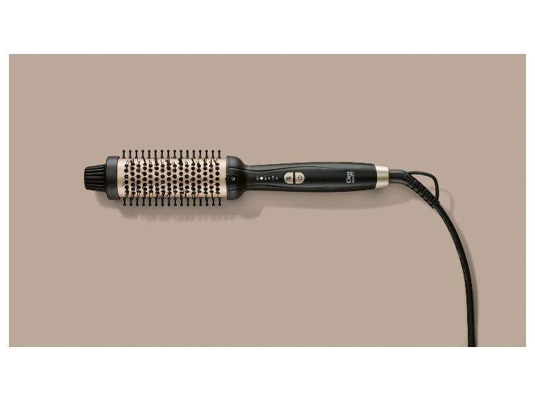 Brosse soufflante noire et dorée avec réglages de température et cordon.