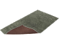 Tapis de bain gris avec motif ondulé et envers antidérapant.