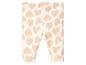 Leggings blanches à motif de cœurs roses.