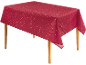 Nappe rouge à motif d'étoiles blanches sur une table en bois.