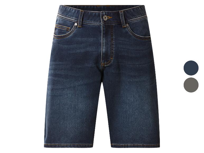 Short en jean bleu foncé avec surpiqûres orange et boutons métalliques.
