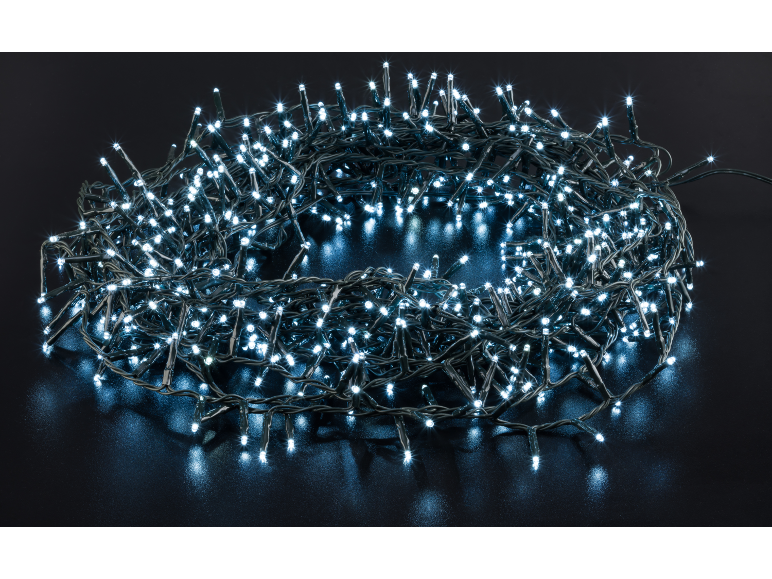 Guirlande de lumières LED blanches enroulée sur une surface sombre.
