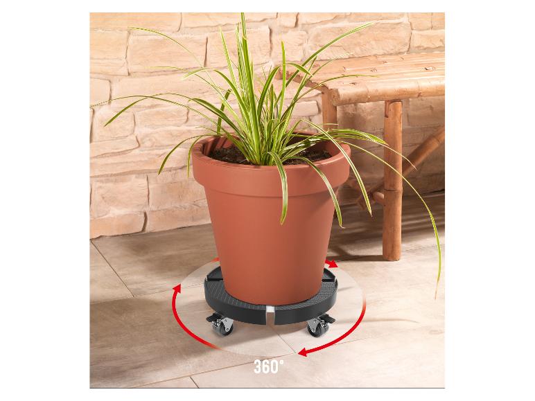 Pot de fleurs sur un support à roulettes noir avec flèches de rotation à 360 degrés sur un sol carrelé.