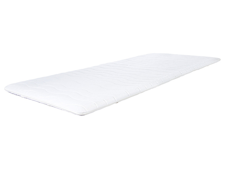 Un matelas blanc avec une texture ondulée.