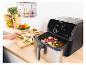 Une friteuse à air Tefal avec un panier rempli de légumes, prête à cuire.