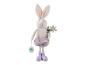 Lapin de Pâques en peluche en salopette violette, tenant une fleur et une étiquette 'Happy Easter'.