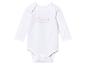 Un body blanc à manches longues pour bébé avec un motif d'animaux et le texte 'best friends forever'.