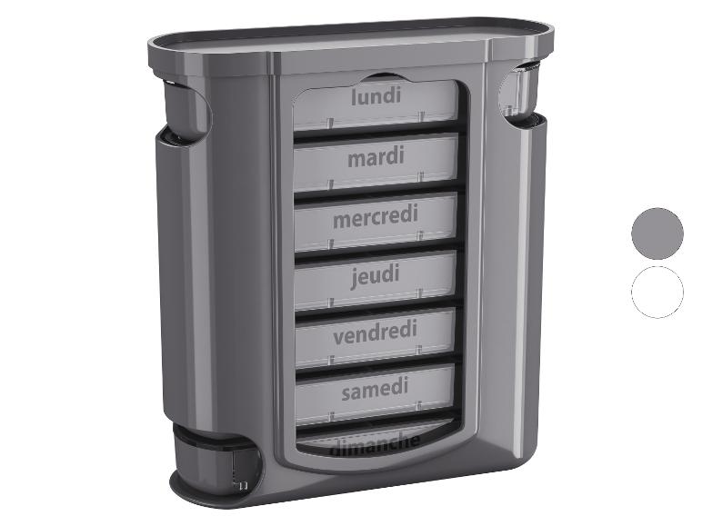 Pilulier hebdomadaire gris avec compartiments étiquetés avec les jours de la semaine.