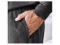 Un homme porte un pantalon de survêtement gris foncé avec une poche.