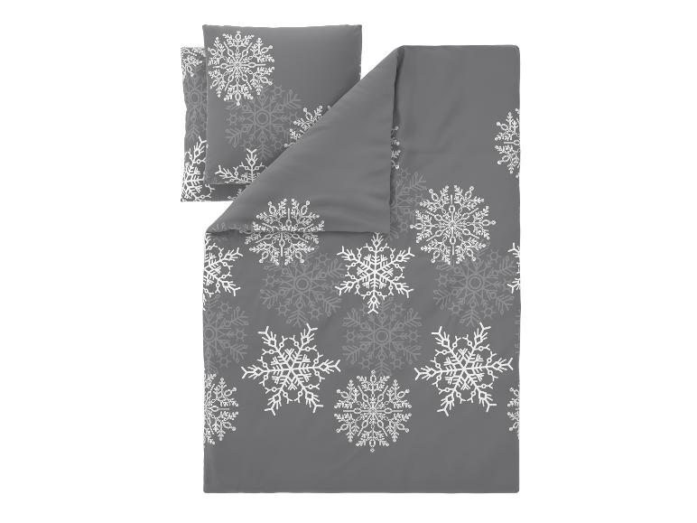 Parure de lit grise avec motifs de flocons de neige blancs.