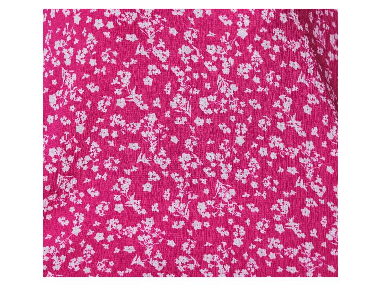 Tissu rose vif à motif floral blanc.