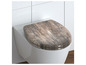 Un abattant de toilette à motif bois.