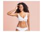 Une femme porte un soutien-gorge et une culotte blancs.
