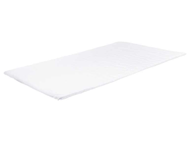Un matelas blanc avec une texture ondulée.