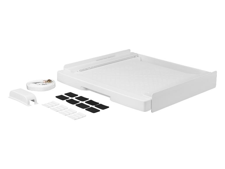 Plateau blanc pour machine à laver avec sangle de fixation et patins antidérapants.