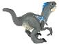 Une figurine de jouet de velociraptor en plastique gris avec des détails bleus.