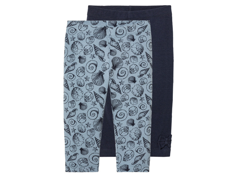 Deux leggings pour filles, l'un à imprimé coquillages et l'autre uni bleu foncé.