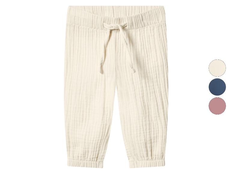 Pantalon en mousseline crème avec cordon de serrage et chevilles élastiques, avec options de couleurs.