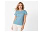 Femme en t-shirt bleu et pantalon blanc
