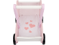 Chariot de marche en bois rose avec poignée blanche et base en tissu à motifs de cœurs.