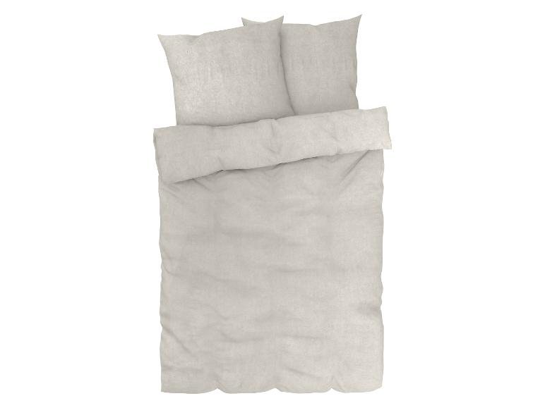 Ensemble de literie beige : drap, taie d'oreiller et taie de traversin.