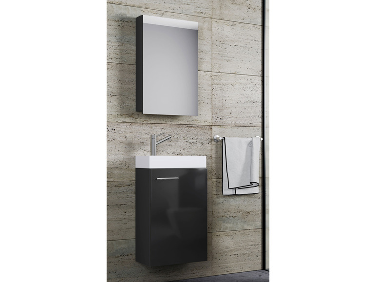 Une armoire de salle de bain noire avec un miroir, un lavabo et un porte-serviettes.