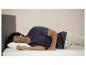 Un homme dort sur un oreiller et un matelas.