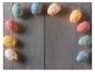 Guirlande lumineuse en forme d'oeufs brillants sur fond bois.