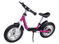 Une draisienne Playtive rose avec des roues argentées.