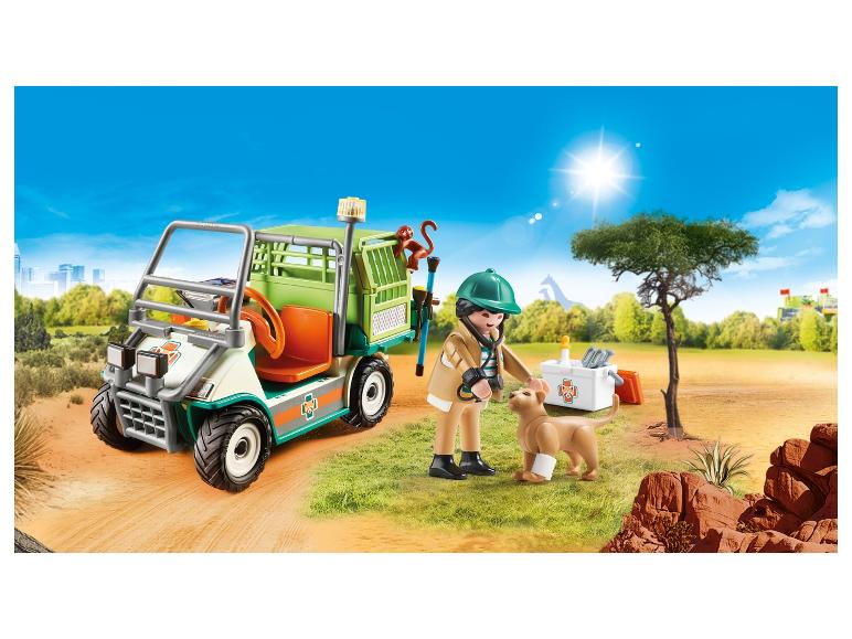 Véhicule vétérinaire Playmobil avec figurine, chien et singe dans un environnement de safari.