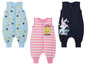 Trois gigoteuses pour bébés avec un motif Looney Tunes.