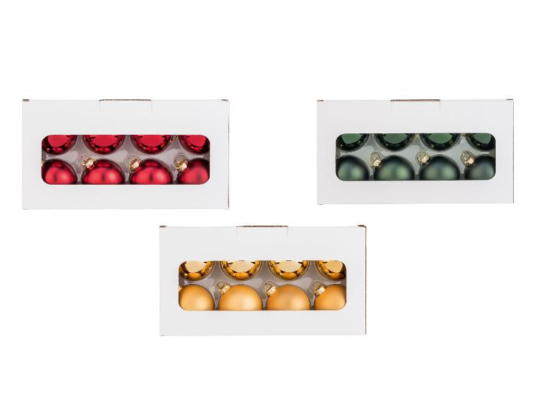 Trois boîtes de boules de Noël LIVARNO® en rouge, vert et or.