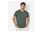 Homme en t-shirt vert foncé avec le texte « Thrive in the unknown » et pantalon clair.