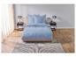 Une couette et des oreillers bleu clair sur un lit avec un tapis gris.