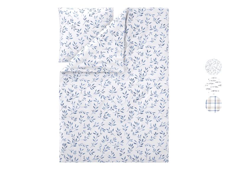 Parure de lit avec motif végétal bleu et motifs supplémentaires.