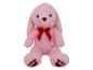Lapin en peluche rose avec nœud rouge et cœurs sur les pattes.