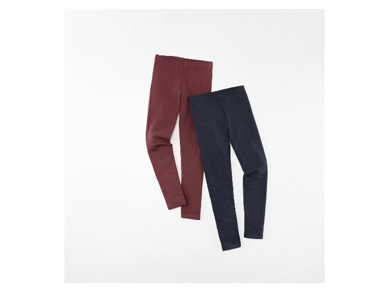 Deux paires de leggings pour enfants, un bordeaux et un bleu marine, posées à plat.